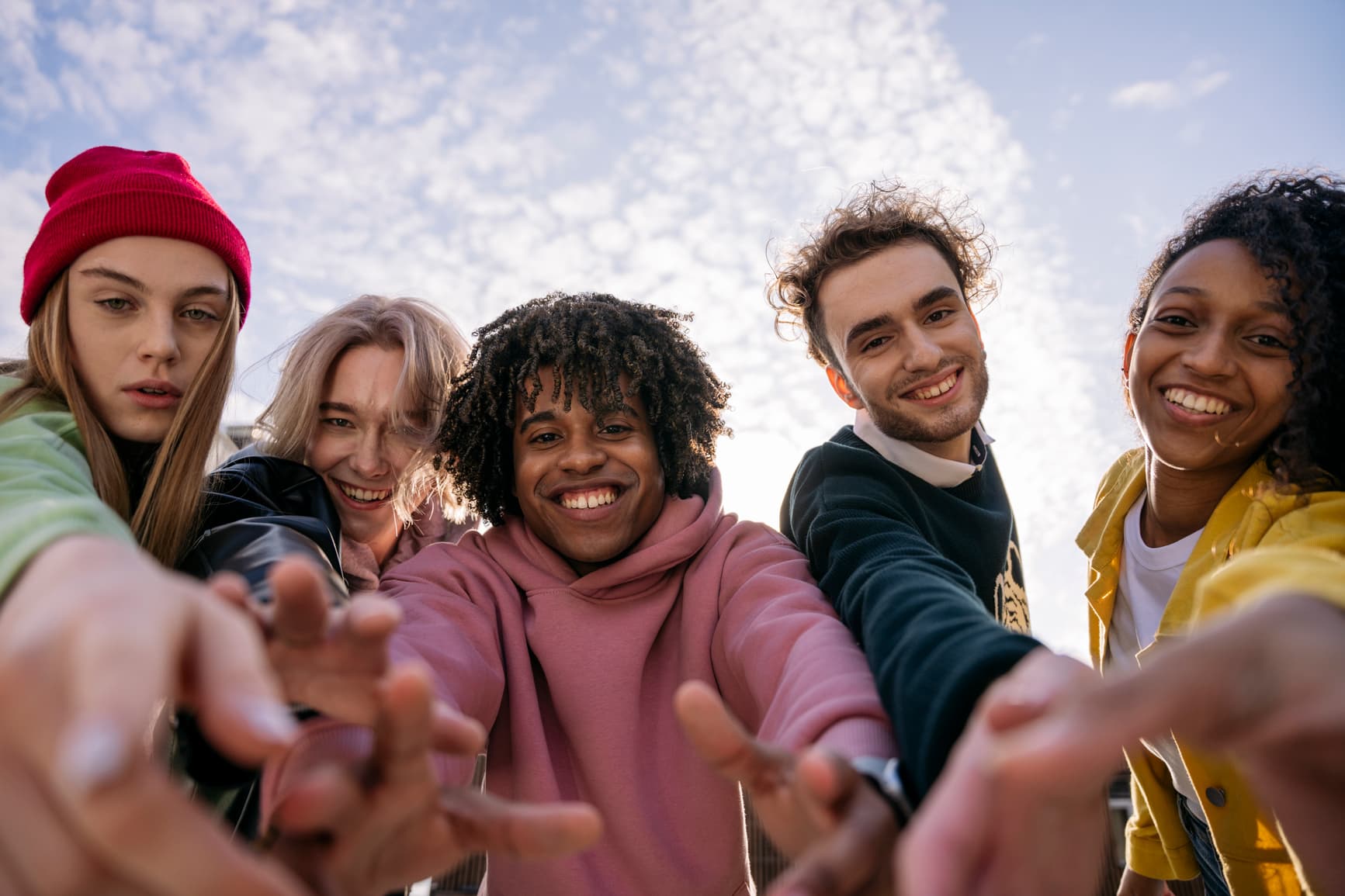 Benefits, tariffs and subsidies: A group of students from different cultures take selfies.