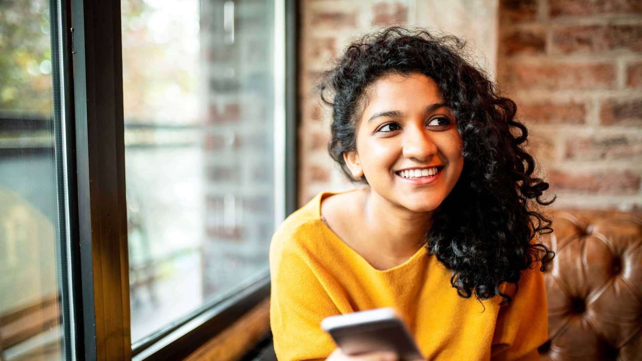 Lächelnde Frau abonniert den DAK-Newsletter