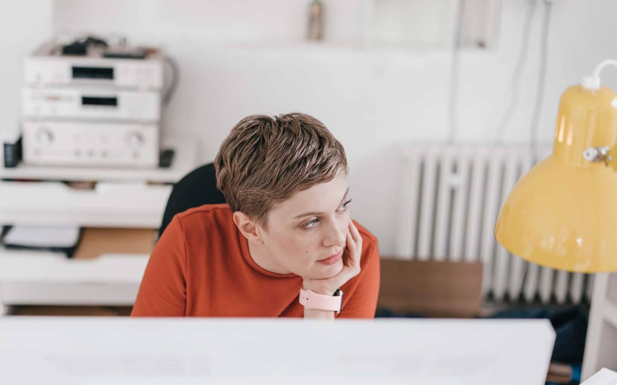 Frau sitzt gelangweilt vor einem Bildschirm