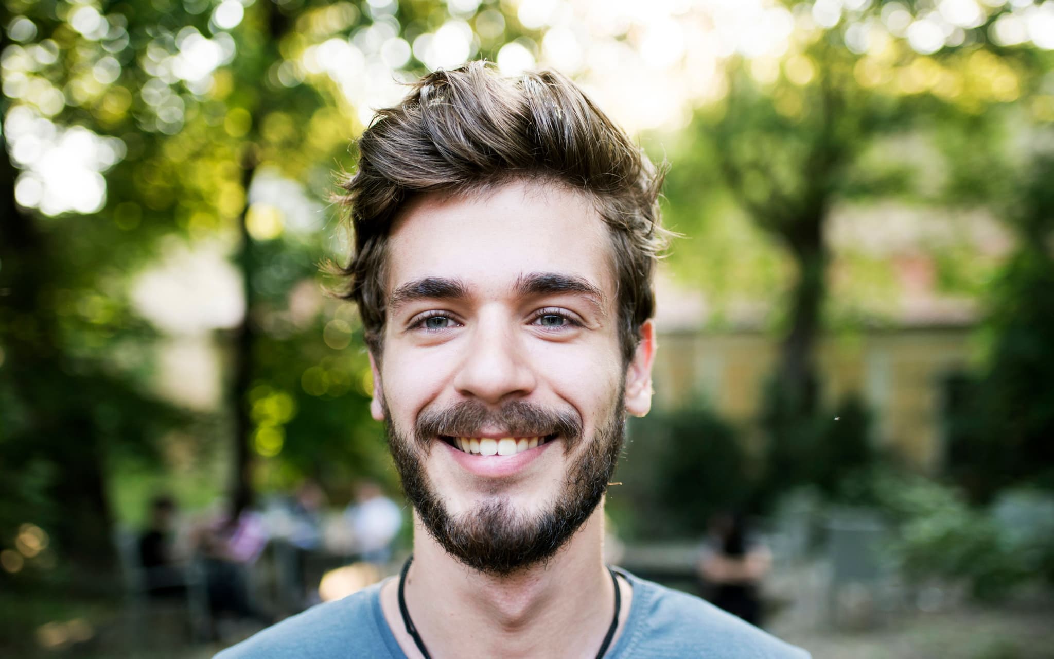 Portret muškarca koji je srećan zbog prednosti osiguranja DAK–Gesundheit.