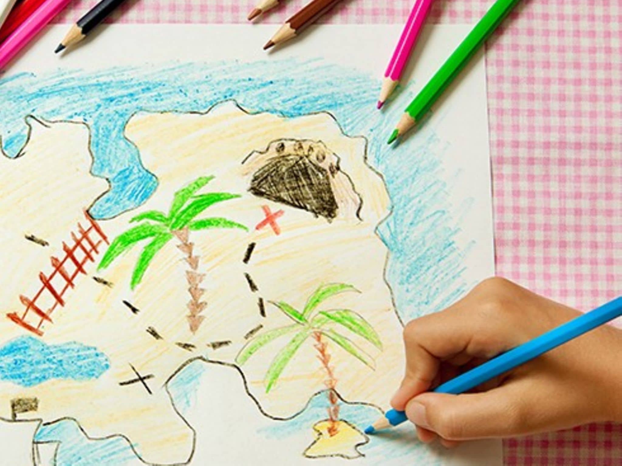 Indoor-Spiele: Gemalte Schatzkarte, Hand mit Stift auf dem Bild.