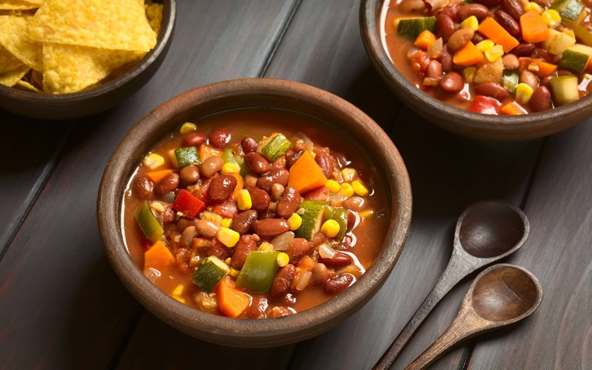 Chili sin carne in zwei braunen Schüsseln angerichet.