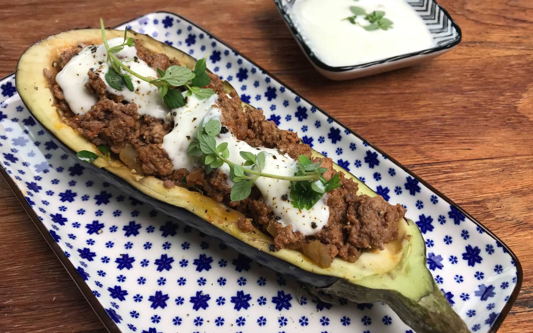 Gefüllte Aubergine: Eine auf einer Servierplatte angerichtete Aubergine