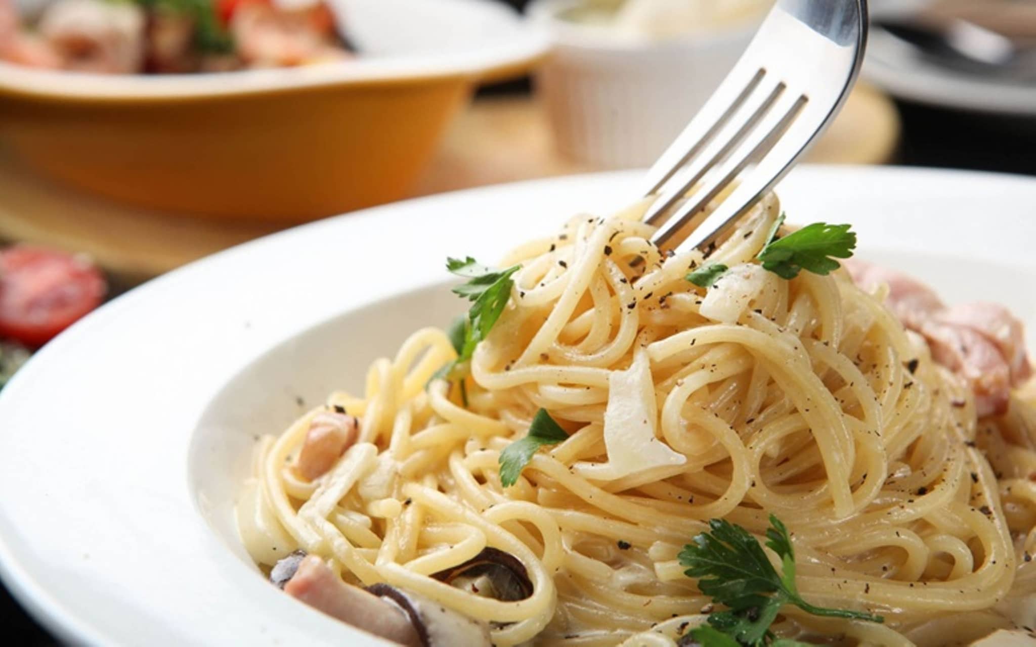 Spaghetti Cabonara: Teller voll mit Spaghetti und eine Gabel