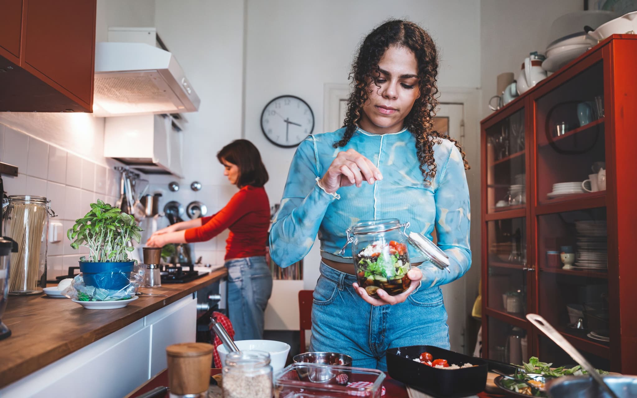 Endometriose & Ernährung: Eine Frau bereitet sich eine gesunde Mahlzeit zu