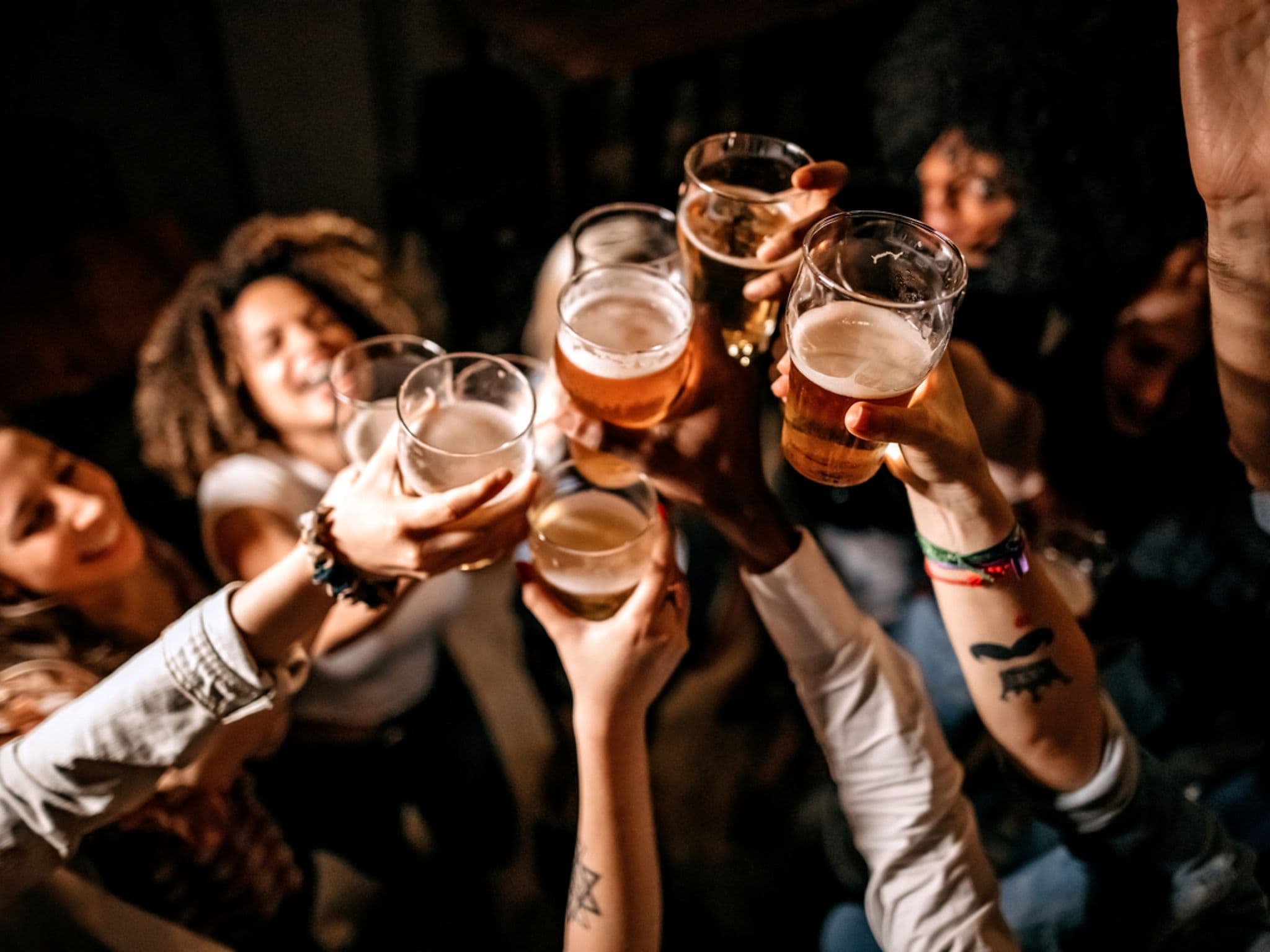 Symbolbild: Menschen prosten sich mit Bier zu
