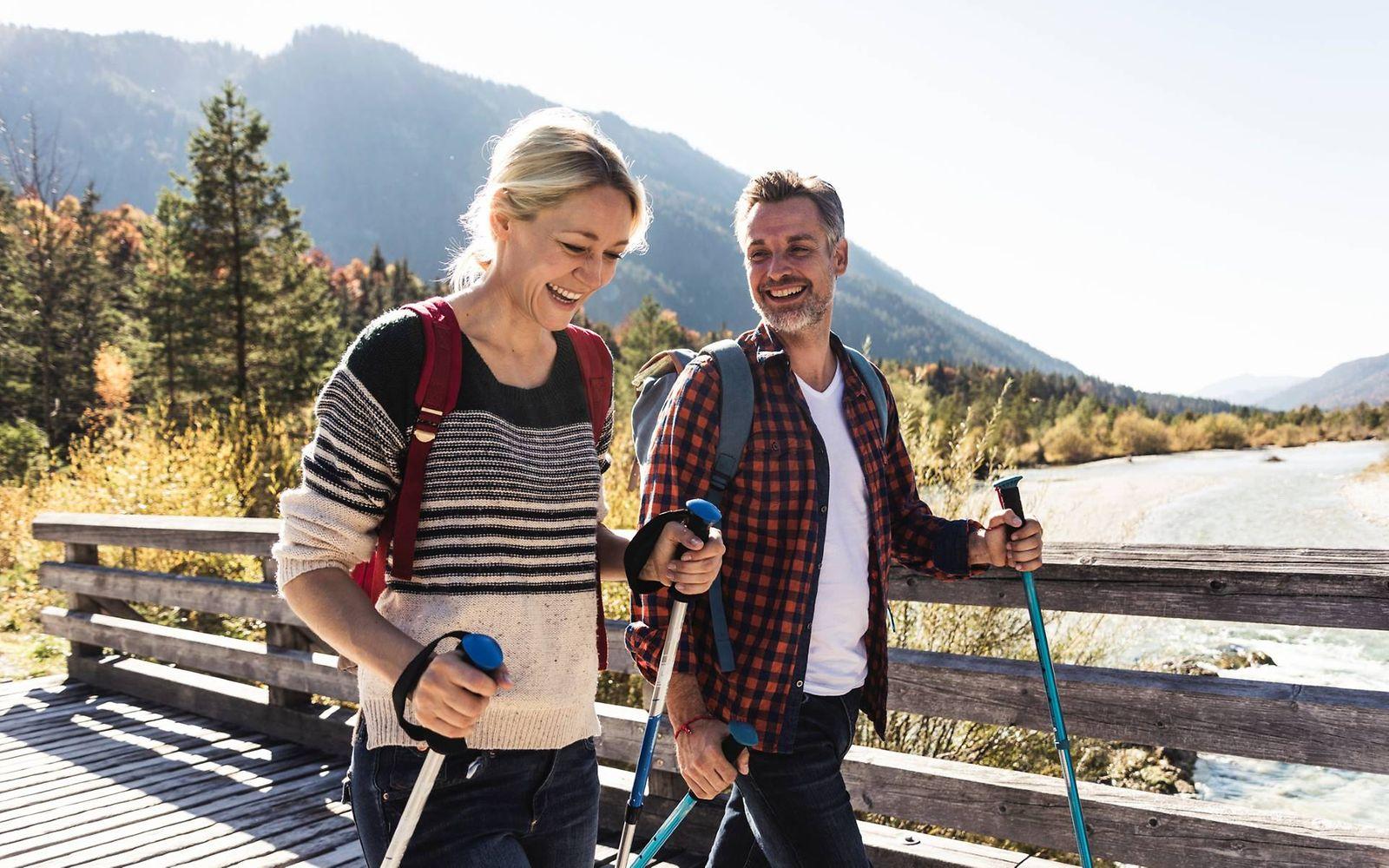 Kniearthrose: Mann und Frau wandern erfreut in den Bergen