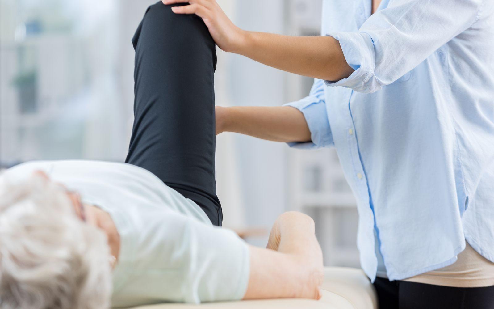Hilfsmittel: Eine Seniorin erhält eine Behandlung am Knie