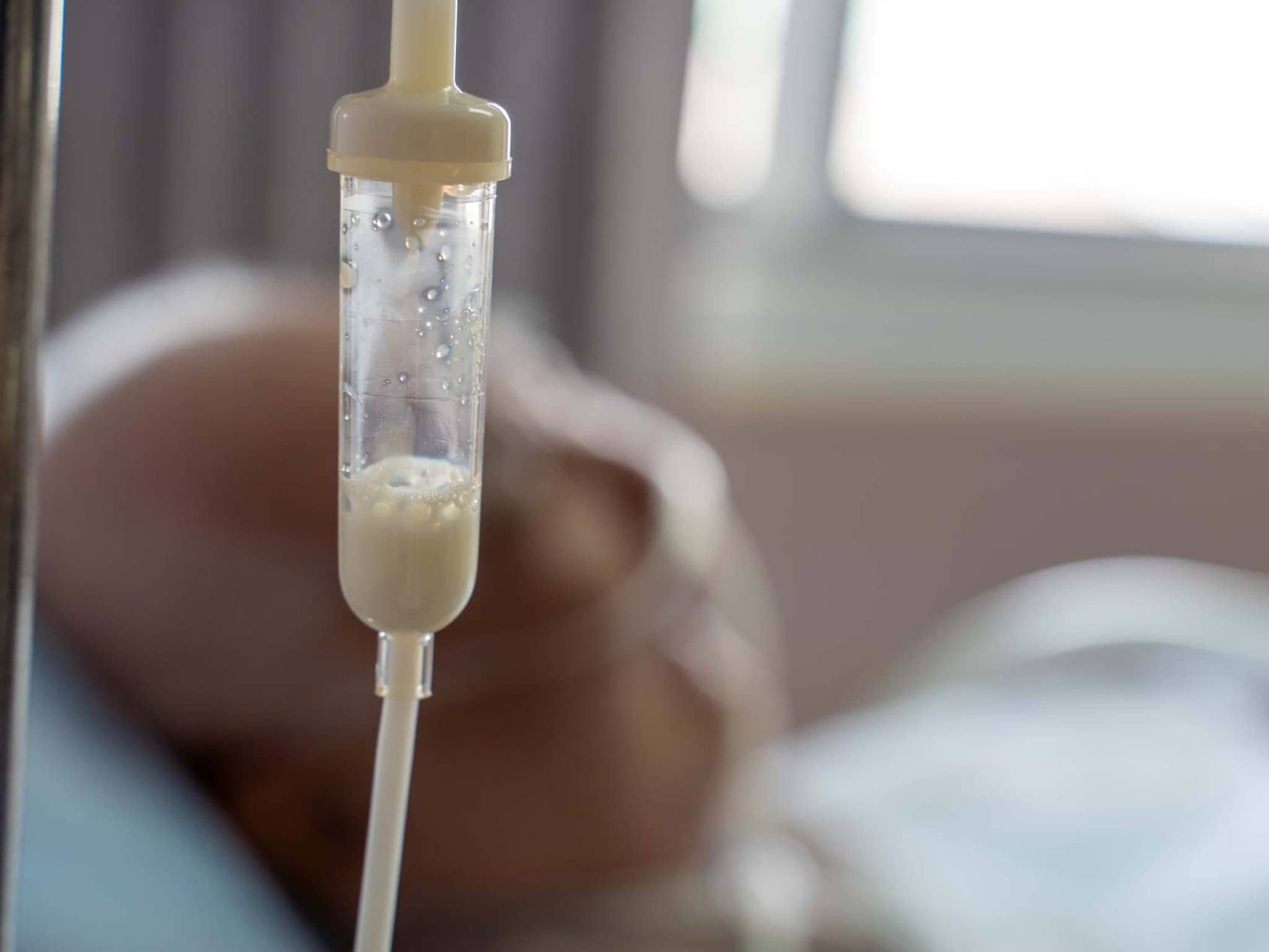 Bild: Eine Person liegt im Bett wird künstlich ernährt