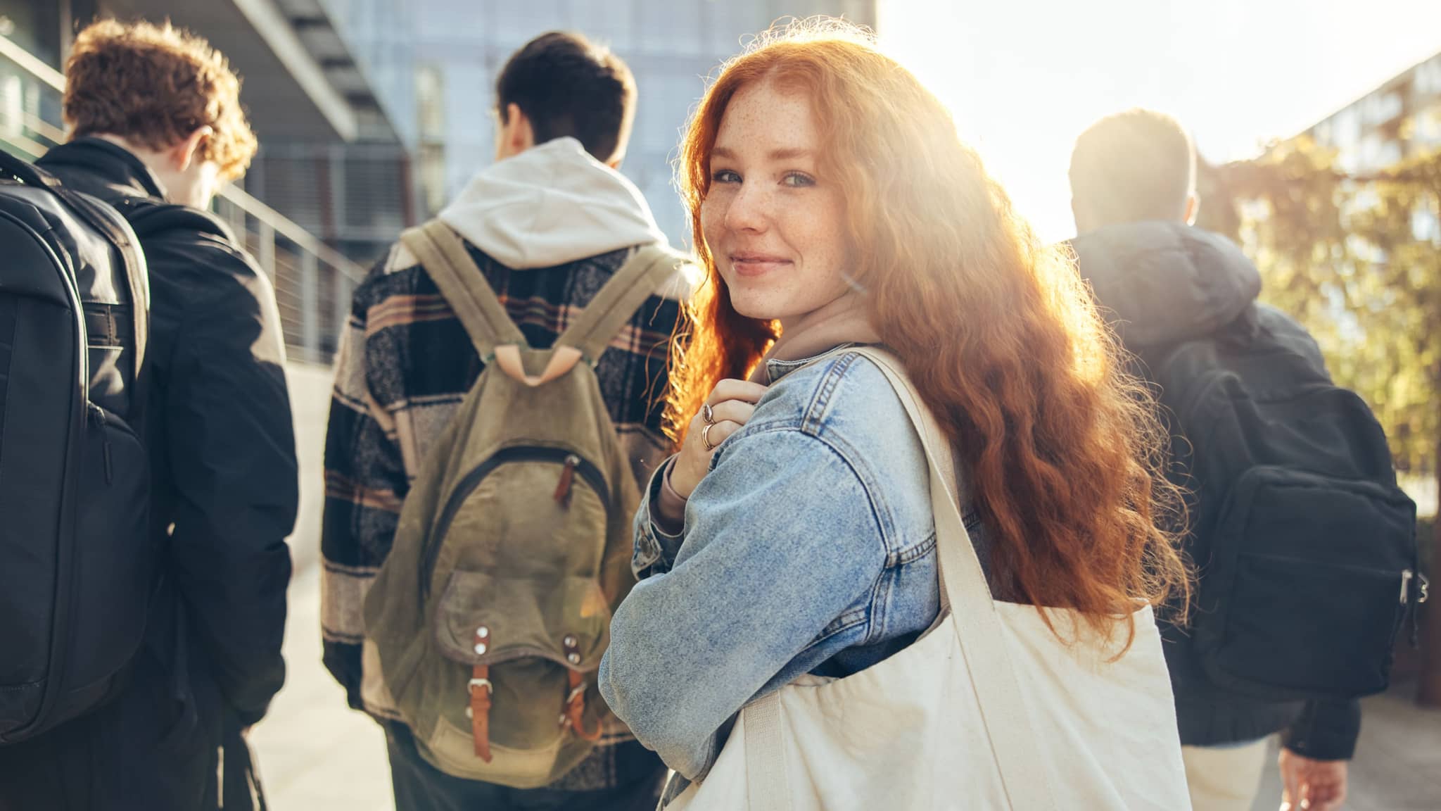 Female student glancing back while going for a class in college.