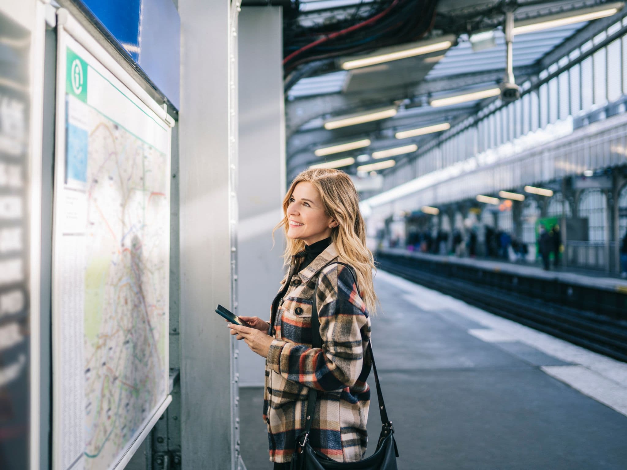 Image: Woman checking the metro plan in Germany