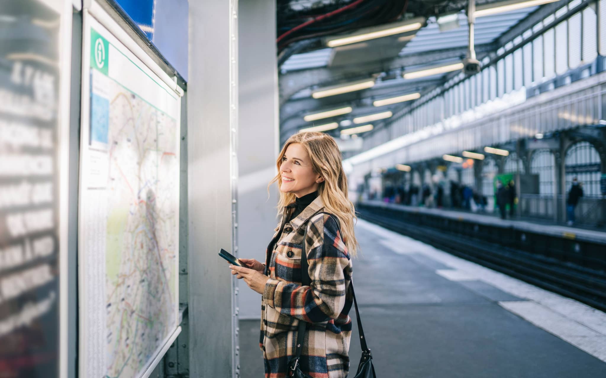 Image: Woman checking the metro plan in Germany