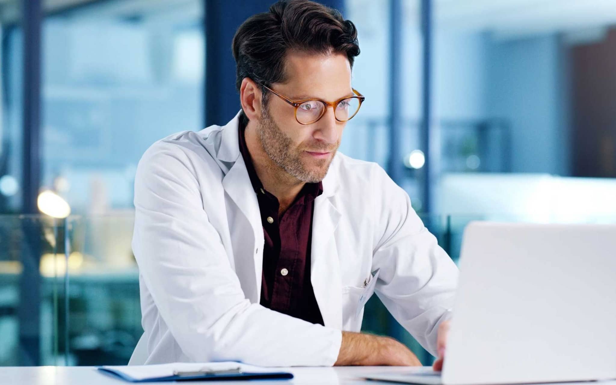 Kommunikation im Medizinwesen (KIM): Arzt sitzt vor Computer