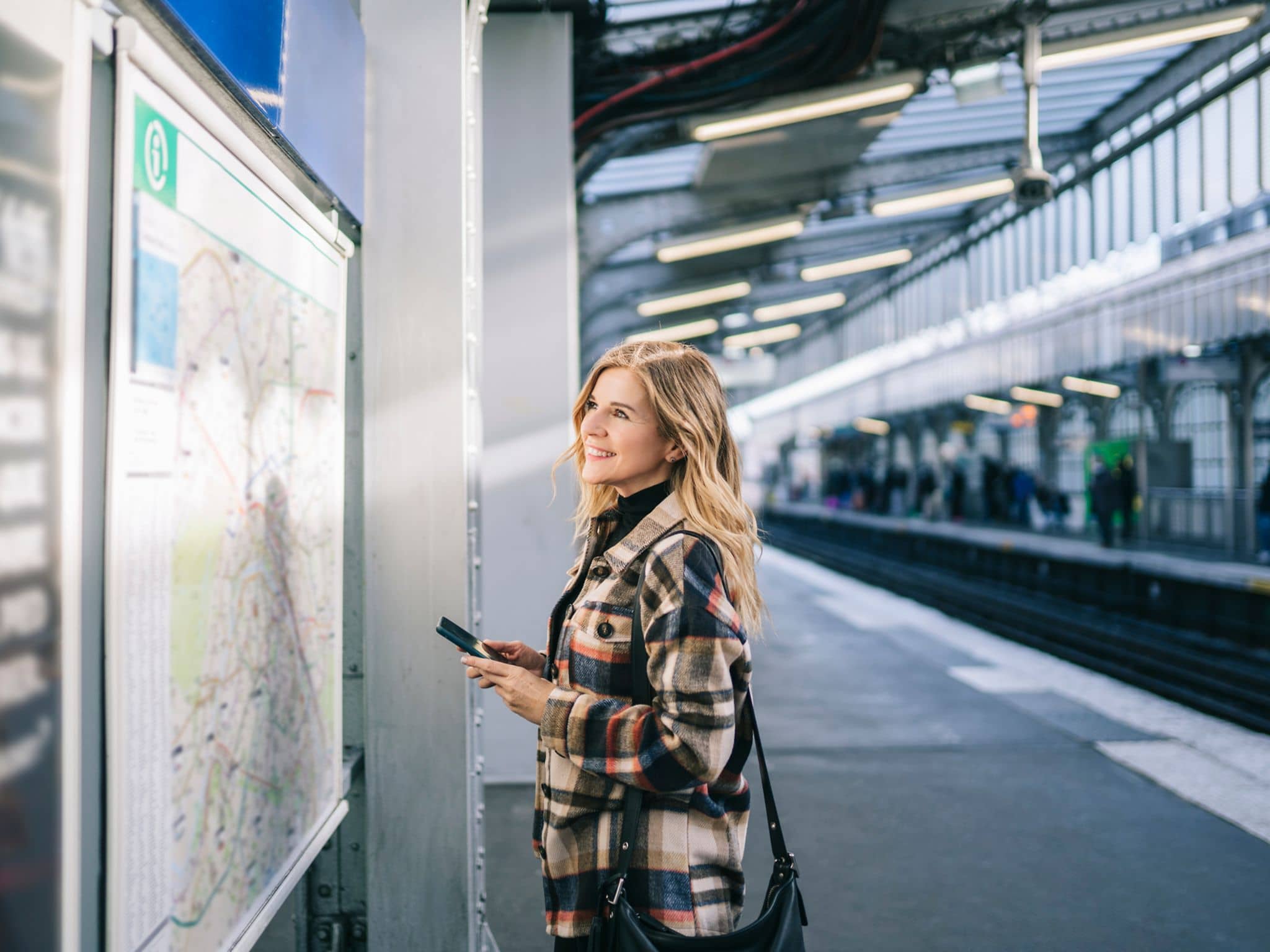 Image: Woman checking the metro plan in Germany